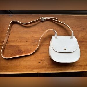 Compact White Leather Crossbody Saddle Bag with Adjustable Strap